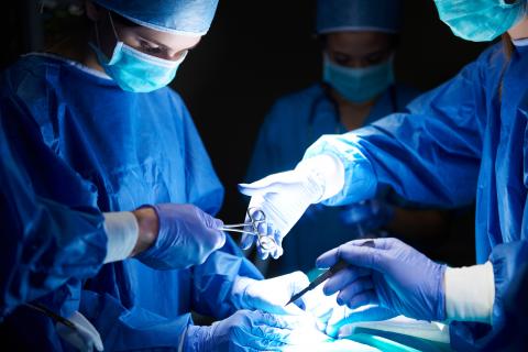Surgeons doing surgery in operating room